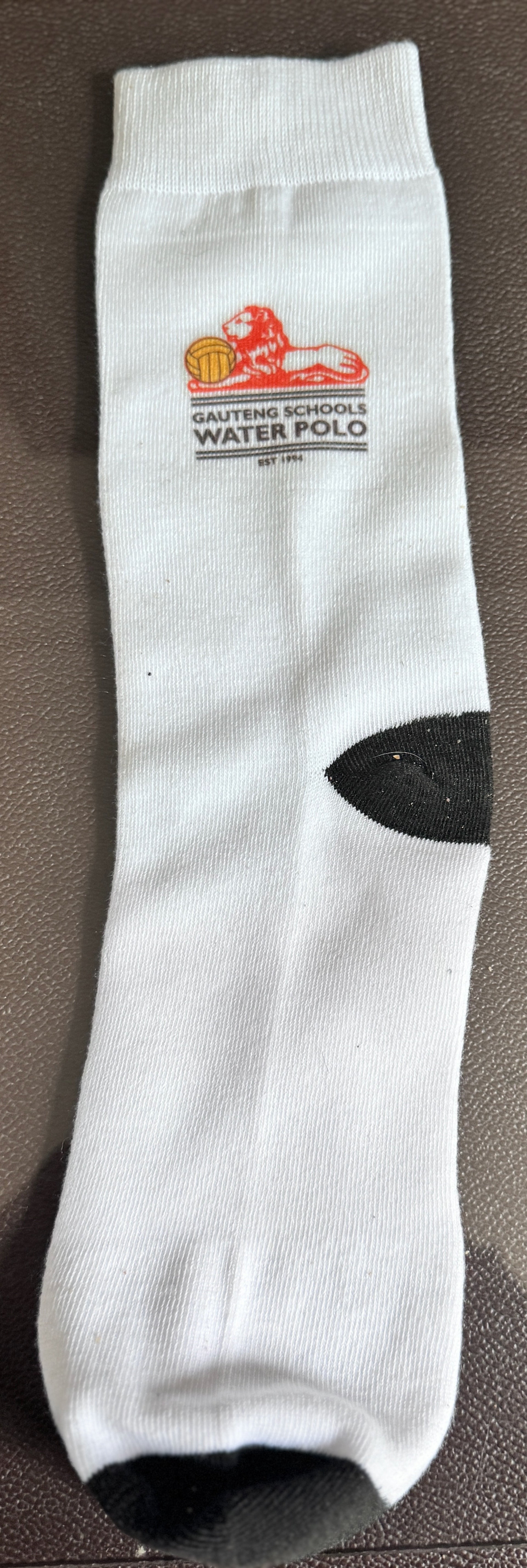 White sock with a logo and text on a brown surface