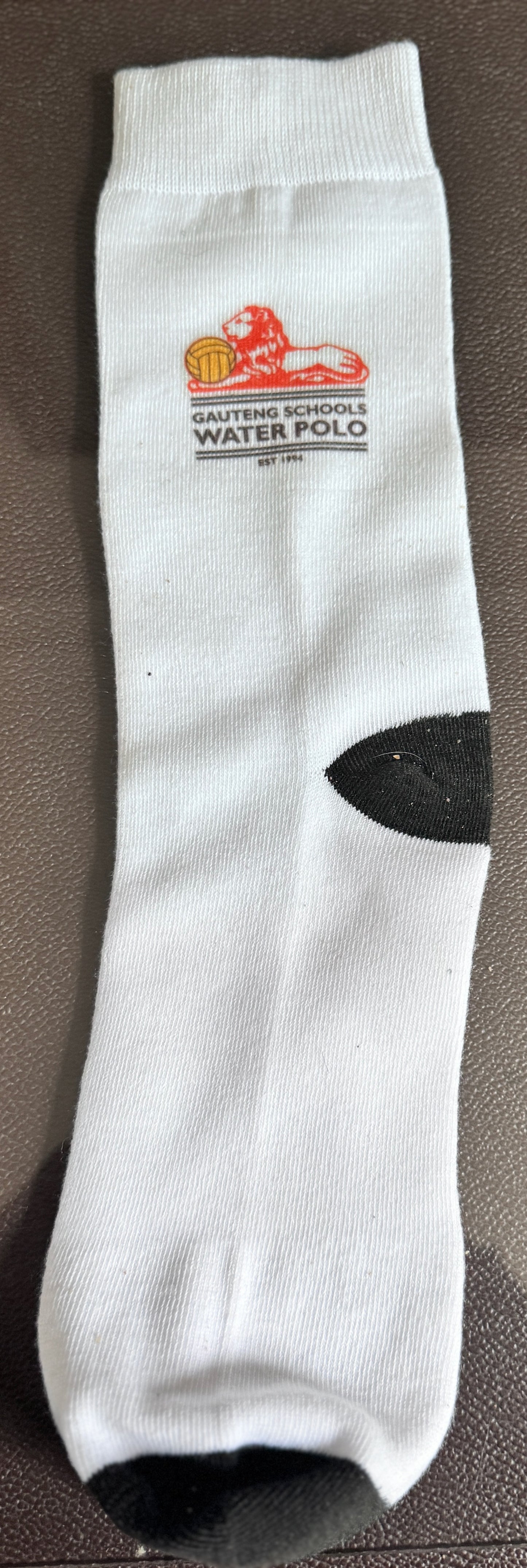 White sock with a logo and text on a brown surface